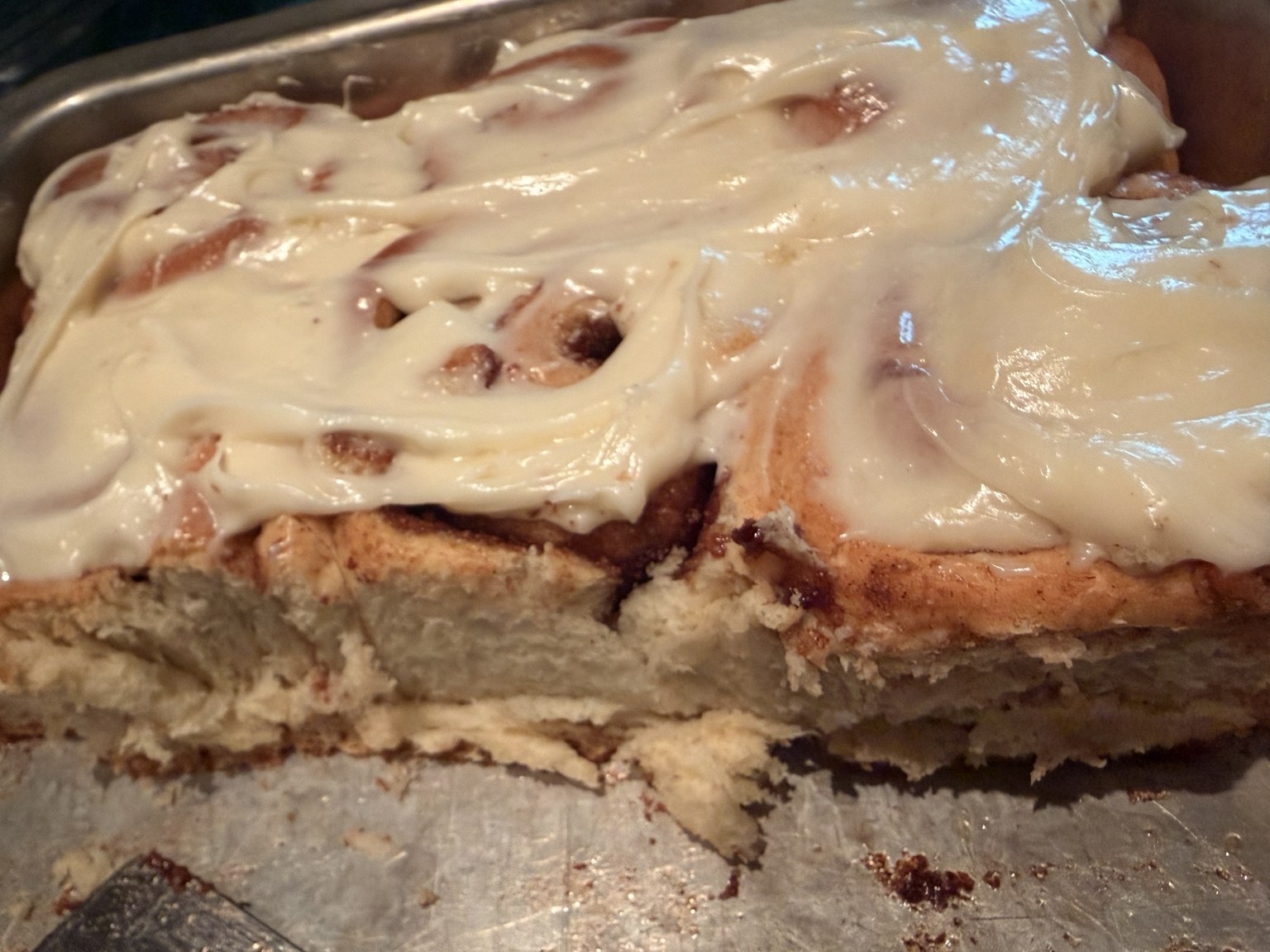Frosted cinnamon rolls in a pan
