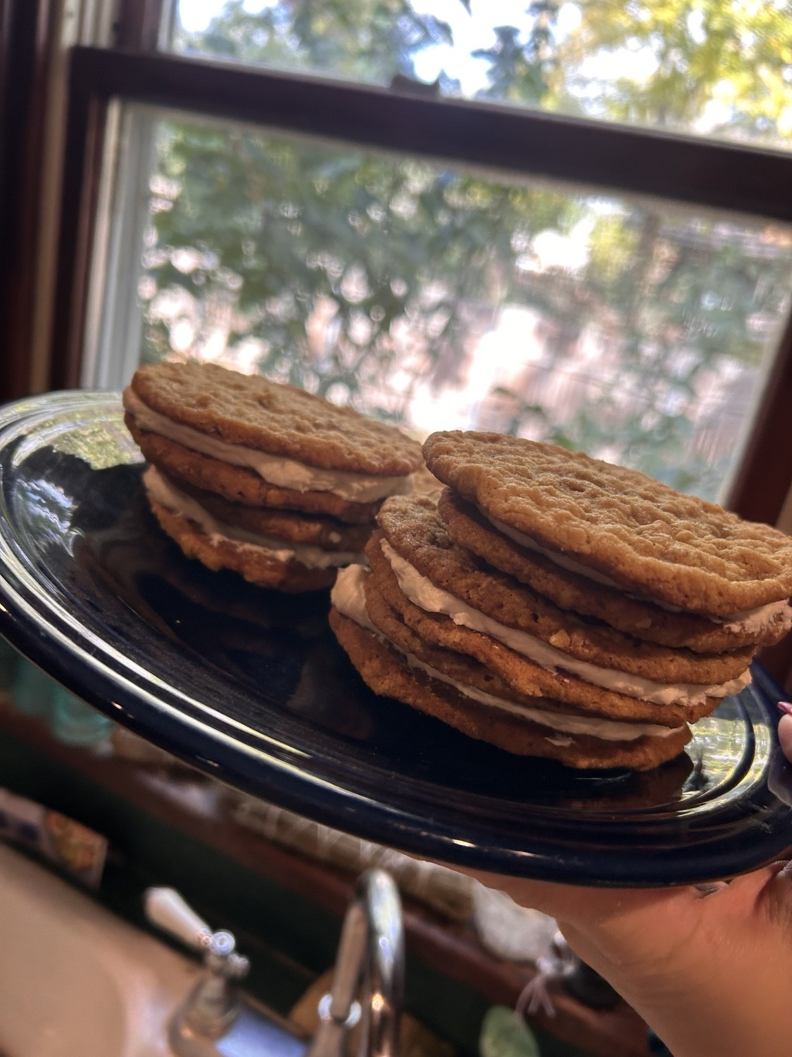 Cream pies stacked on a black plate